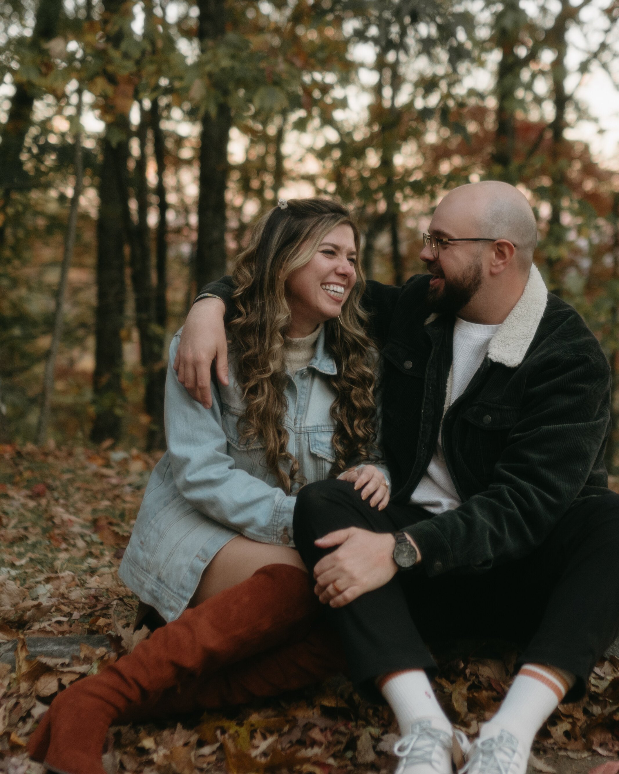 Sitting on the forest floor in a drift of brown leaves, in denim and corduroy, laughing at each other.